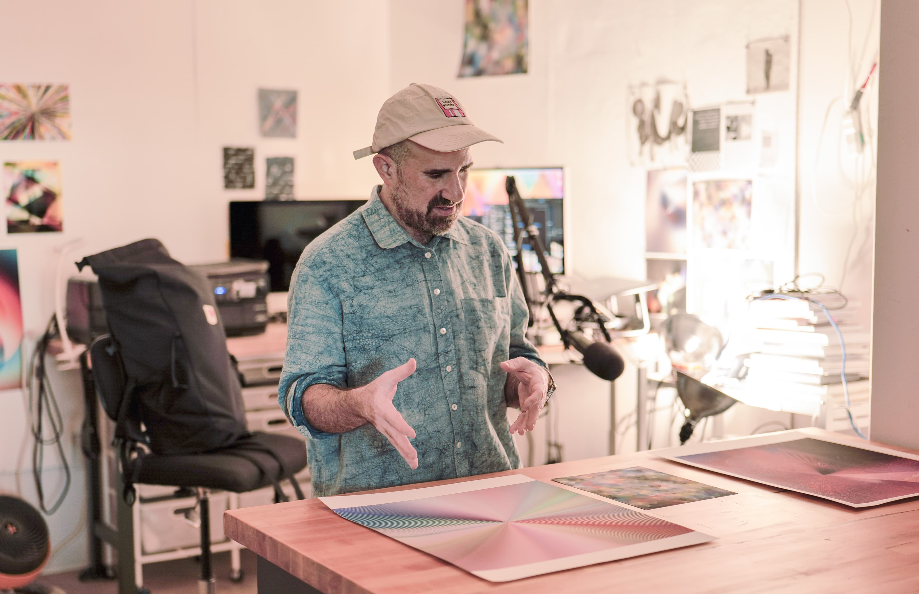 Three image row 2 Lieberman reviewing prints from his practice in his studio.